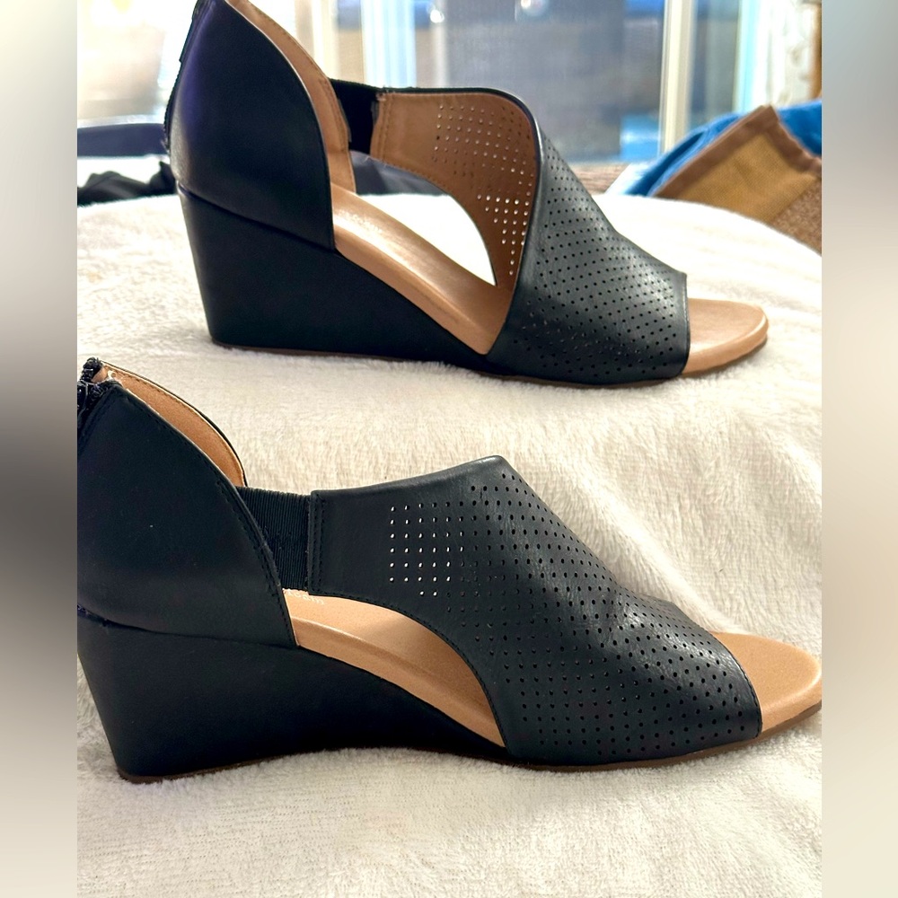 Black open-toed shoes with a modern curve style.
